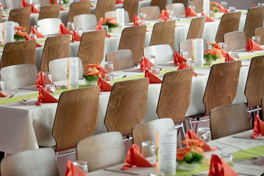 A banquet hall is prepared for an event