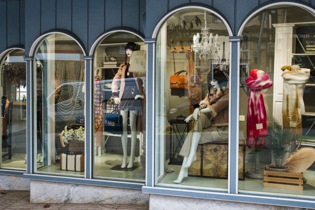 A store window display featuring dressed mannequins