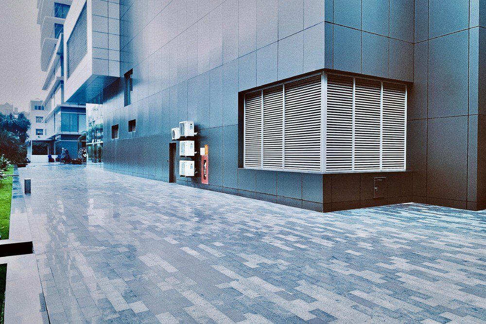 A commercial building with a tile and grout walkway