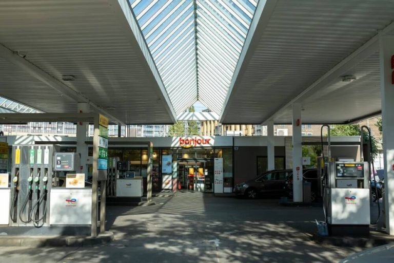 A view of the gas pumps and entryway of a gas station