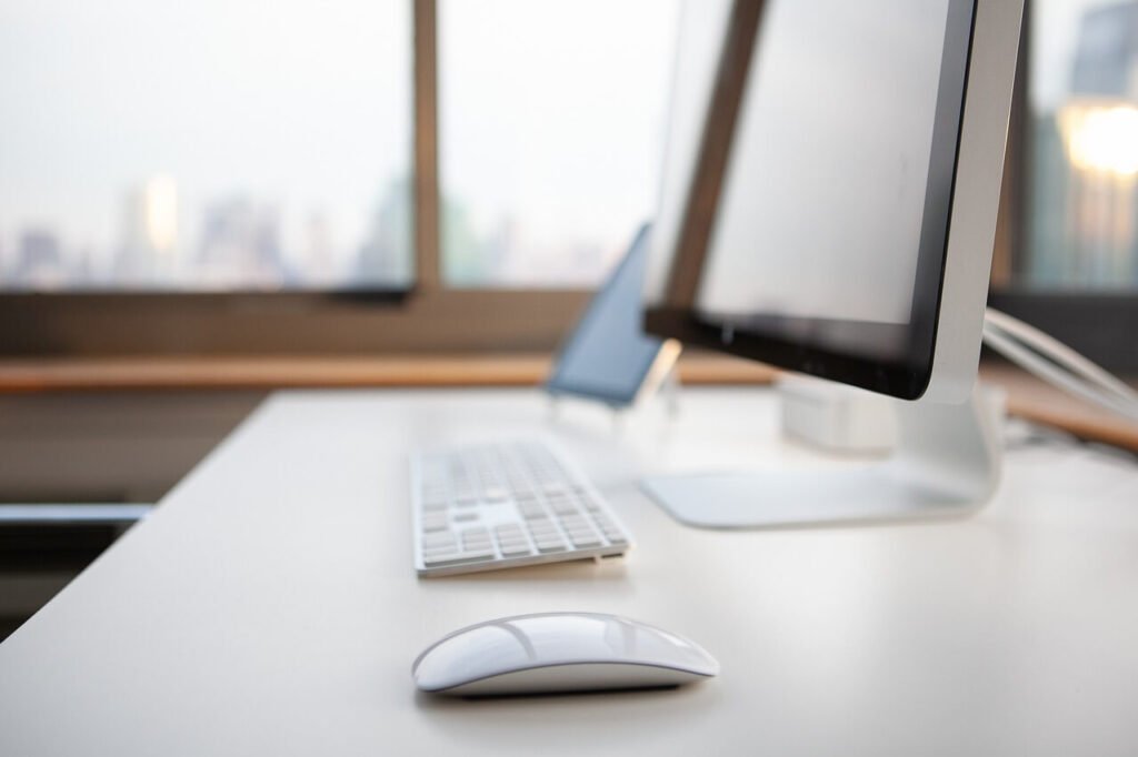 A desk with a computer, keyboard, and mouse on it