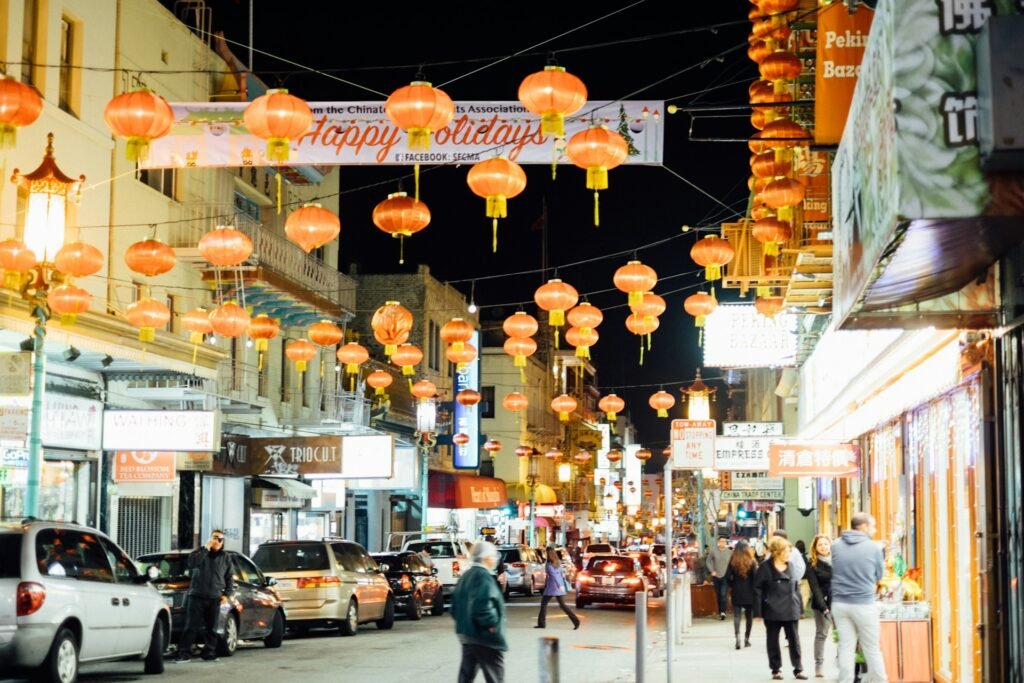 San Francisco’s Chinatown is lit up at night with people bustling