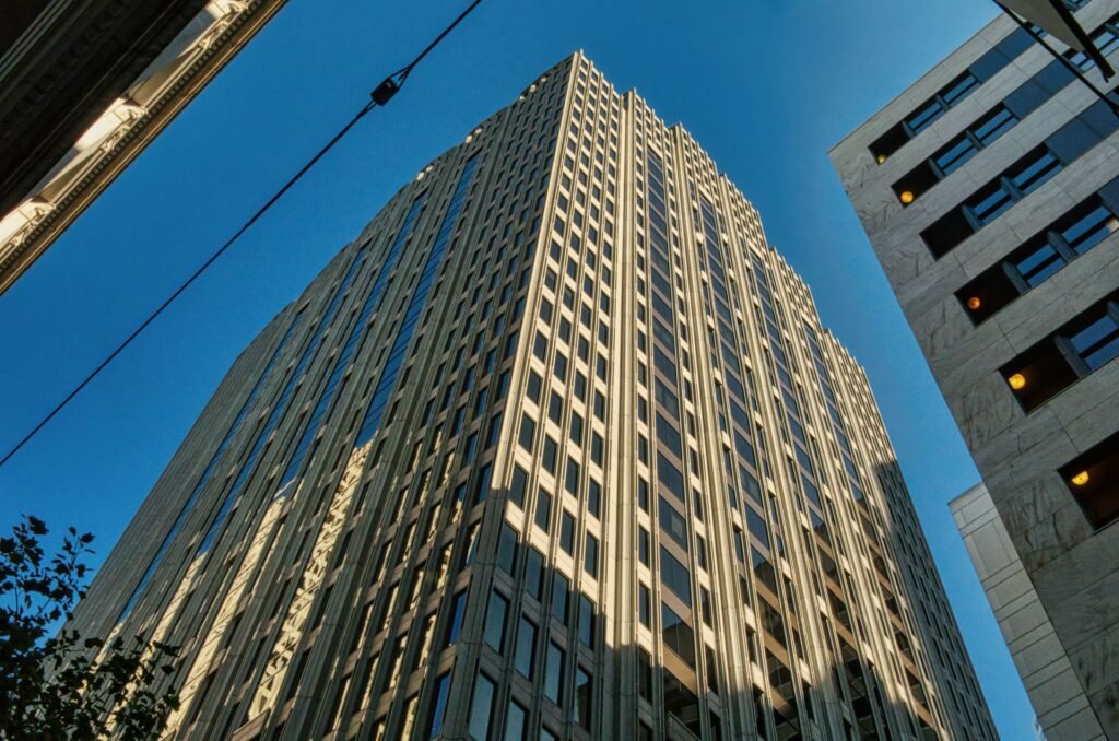 A low-angle shot of a San Francisco skyscraper against a blue sky